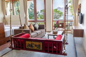 a living room with a swing and a bed at Jaisamand Island Resort in Udaipur
