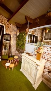 a kitchen with a counter and stools in a yard at Casa Susa in Poio