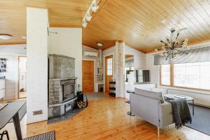 a living room with a couch and a fireplace at Villa Veneskoski in Veneskoski