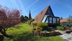a house with a garden in front of it at Villa Aurora in Waldbrunn