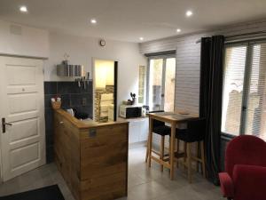 a kitchen with a counter and a table with chairs at La Chantrerie in Cahors