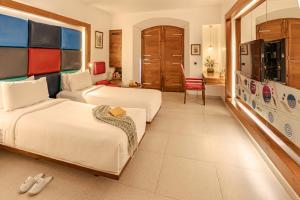 a hotel room with two beds and a tv at The Promenade in Pondicherry