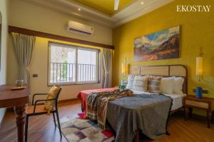 a bedroom with a bed and a window at EKOSTAY - Casa Elara in Igatpuri