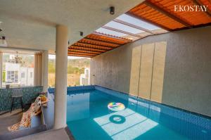 a swimming pool in a house with a swimming pool at EKOSTAY - Casa Elara in Igatpuri