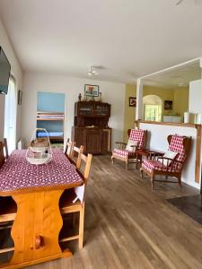 a living room with a table and chairs at Maison David in Nantiat