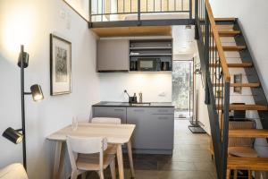 a kitchen and dining room with a table and a staircase at Appartements Lago in Tüscherz-Alfermée +33 photos