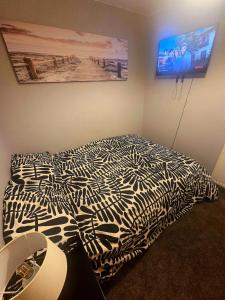 a bedroom with a zebra print bed in a room at Clover Ground Home in Bristol