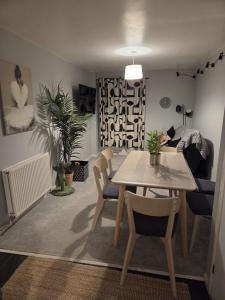 a living room with a table and chairs and a couch at Clover Ground Home in Bristol