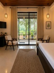 a hotel room with a bed and a desk and chairs at Myla Lodge in Anuradhapura