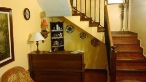 a room with a staircase with a table and a lamp at Casa Maidevera in Aranda de Moncayo