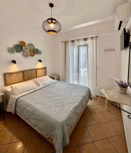 a bedroom with a large bed in a room at Celeste Apartments in Ornos