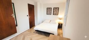 a small bedroom with a bed and a table at Ô Cœur d'Objat - Baby-foot - Clim in Objat