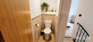 a small bathroom with a toilet in a hallway at Ô Cœur d'Objat - Baby-foot - Clim in Objat