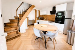 a kitchen and dining room with a wooden table and chairs at Ô Cœur d'Objat - Baby-foot - Clim in Objat