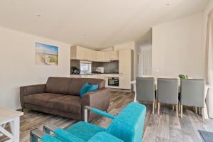 a living room with a couch and a table at De Ankergooi! in Hardenberg