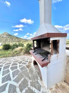 an outdoor pizza oven sitting on a patio at Sergio's homes in Mélanes