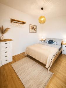 a bedroom with a bed and a white dresser at Apartment Harbach in Harbach