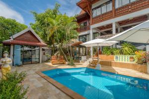 an exterior view of a resort with a swimming pool at Penthouse Crystal Bay Apartments in Lamai
