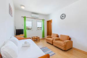 a living room with a bed and a couch and a tv at HI Alcoutim – Pousada de Juventude in Alcoutim