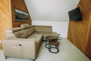 a living room with a couch and a table at Apartament CEKO 2 in Ostrowsko
