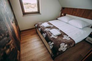 a bedroom with a bed with two towels on it at Apartament CEKO 2 in Ostrowsko +18 photos