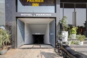 a motorcycle parked in front of a hotel parking garage at Airport Premier In With Free Airport Drop in New Delhi