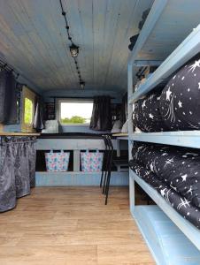 a room with shelves with pillows on them at Andělka maringotka in Humpolec