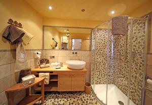 a bathroom with a tub and a sink and a shower at Appartamenti Loretta in La Villa +14 photos