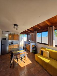 a living room with a yellow couch and a table at Villa Puglia AR 700m from beach -max 4 people- in Bisceglie
