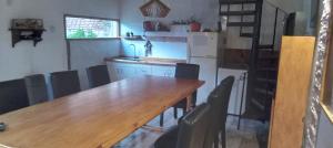 a kitchen with a long wooden table and chairs at Días y flores in Ranchos