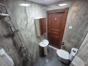 a bathroom with a toilet and a sink at Sabah Pansiyon in Antalya +46 photos