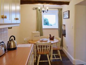 a kitchen with a small table and a window at Dewsnap Frost - Rb8 in Chinley