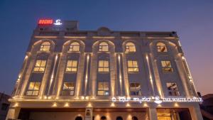 a large building with a sign on top of it at The White Castle Hotel in Mysore
