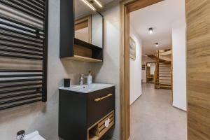 a small bathroom with a sink and a mirror at Alpine HOUSE 77 in Kranjska Gora +41 photos