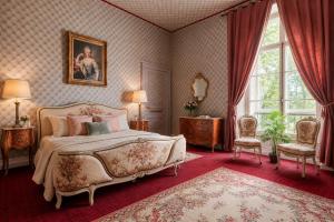 a bedroom with a large bed and a large window at Private Château with sauna, hot tub & 4ha park - Château Guillermo in La Moncelle