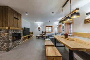 a living room with a couch and a fireplace at Alpine HOUSE 77 in Kranjska Gora