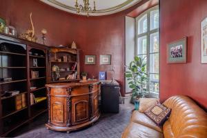 a living room with a large wooden island in a red wall at Private Château with sauna, hot tub & 4ha park - Château Guillermo in La Moncelle