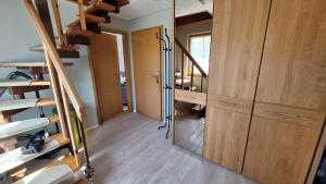 a room with a staircase and a room with a mirror at Ferienwohnung Strandweg 1 in Wieck
