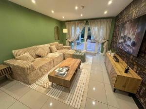 a living room with a couch and a table at Stylish 2 Bed Flat Parking Sutton Coldfield in Birmingham