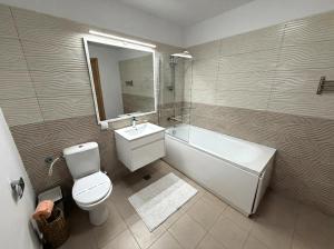 a bathroom with a tub and a toilet and a sink at Negru Voda 9- Old Town in Constanţa