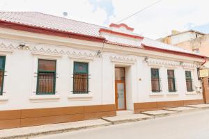 a white building on the side of a street at Negru Voda 9- Old Town in Constanţa