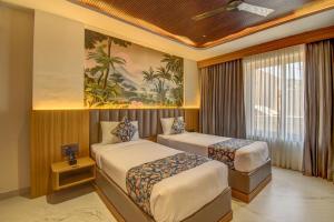 a hotel room with two beds and a painting on the wall at The White Castle Hotel in Mysore