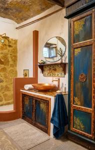 a bathroom with a wooden sink and a mirror at Casa d'Artista con Terrazza Panoramica nel Borgo" Ajman house in Sambuca di Sicilia