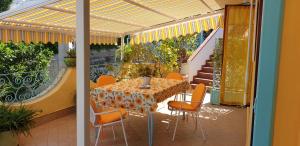 a dining table and chairs on a patio with a balcony at Alloggio vacanza di Michele in Casamicciola Terme +12 photos