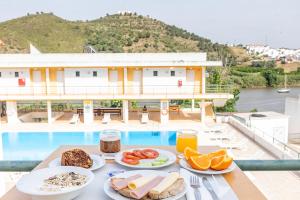 a table with plates of food on top of a cruise ship at HI Alcoutim – Pousada de Juventude in Alcoutim
