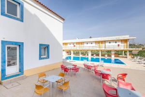 a patio with tables and chairs next to a pool at HI Alcoutim – Pousada de Juventude in Alcoutim