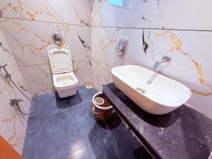 a bathroom with a sink and a toilet at Hotel Radhe Residency Taloja MIDC - Only accomodate Indian citizens in Panvel +34 photos