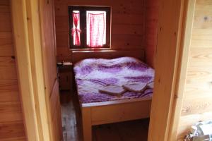 a small room with a bed in a cabin at BB Etno House in Kolašin