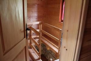 an inside view of a wooden cabin with a staircase at BB Etno House in Kolašin