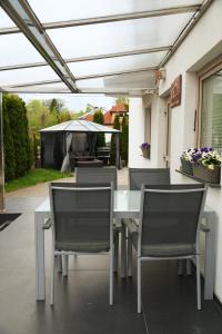a patio with a table and chairs under a pergola at Villa Viola in Mielno